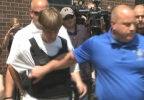 Dylann Roof is led to a police car Thursday, courtesy of credit WSOC-TV.