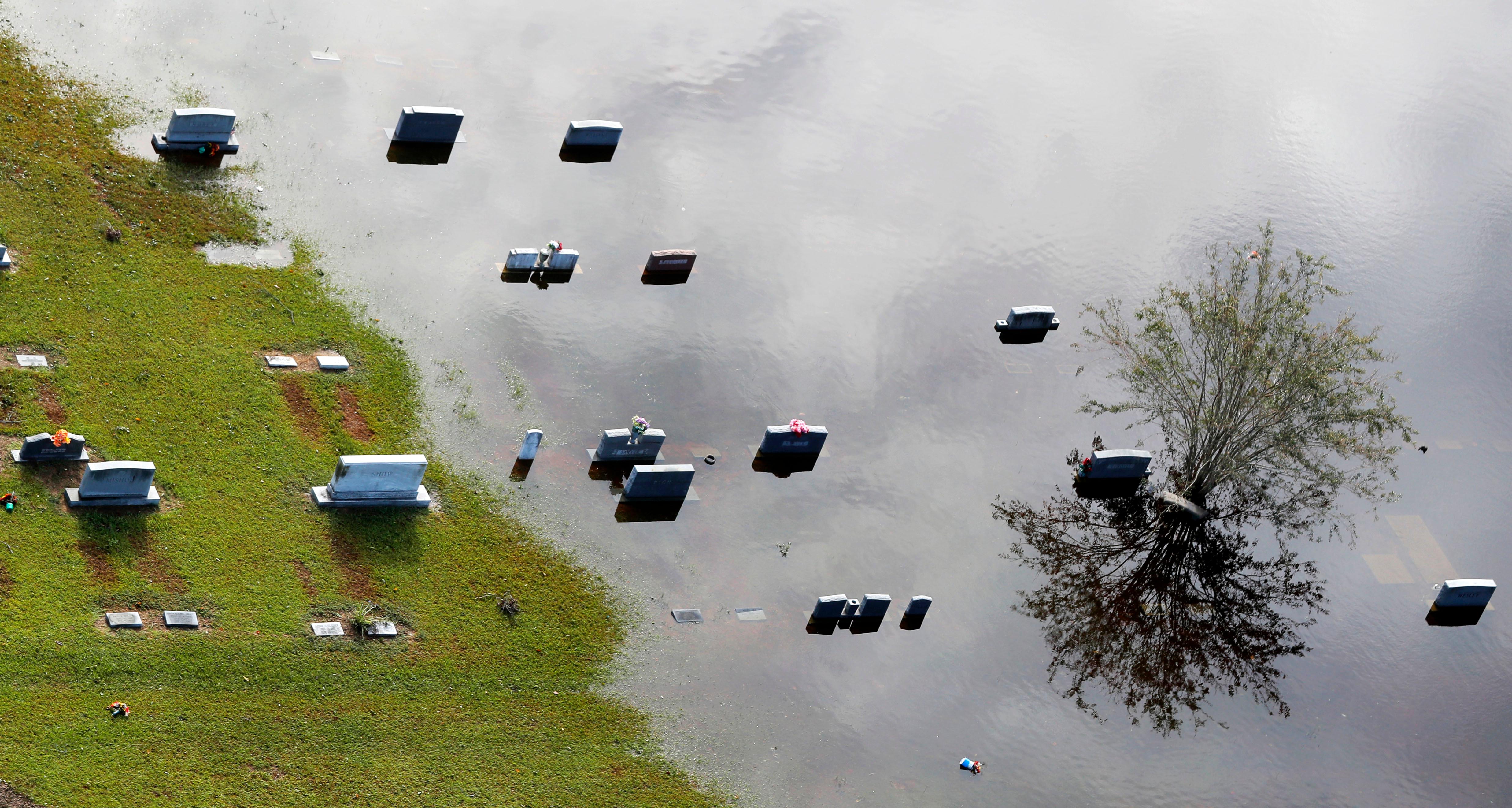 tombstones sit submerged in floodwaters from hurricane florence